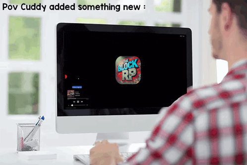 a man sits in front of a computer screen that says the block r9