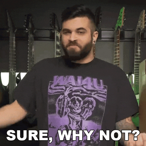 a man with a beard wearing a purple shirt that says sure why not