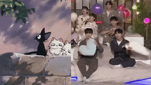 a group of people are sitting on a bed in front of a cat