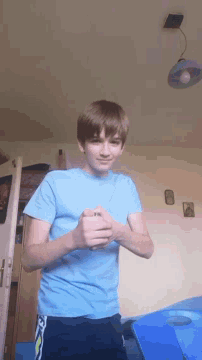 a young boy in a blue shirt with the letter n on it