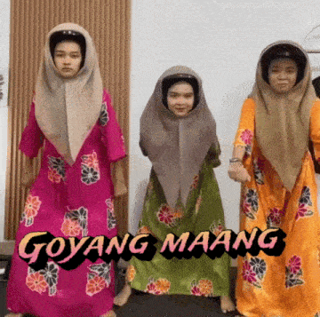 three women wearing hijabs and goyang maang dresses dancing