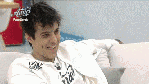 a man wearing a white shirt that says amici on it