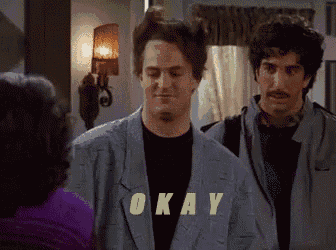 two men are standing next to each other with the word okay written on their shirts