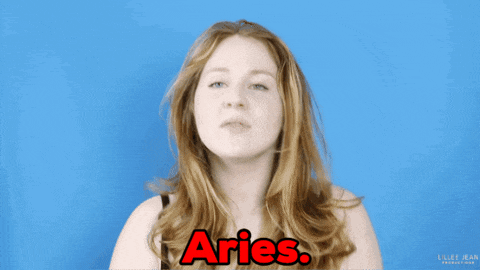a woman is making a funny face with the word aries in red