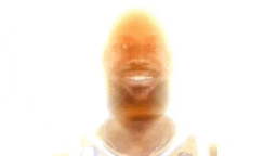 a blurry picture of a man with a beard and a white shirt .