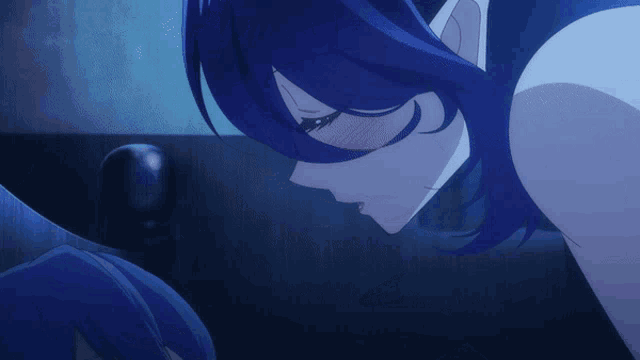 a man and a woman are kissing in a dark room