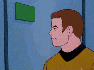 a man in a yellow shirt is looking at a green sign