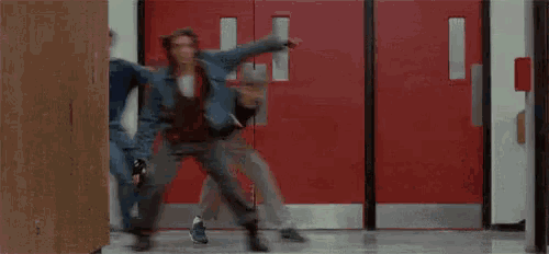 a group of people are running through a hallway with the word rente written on the bottom of the image .