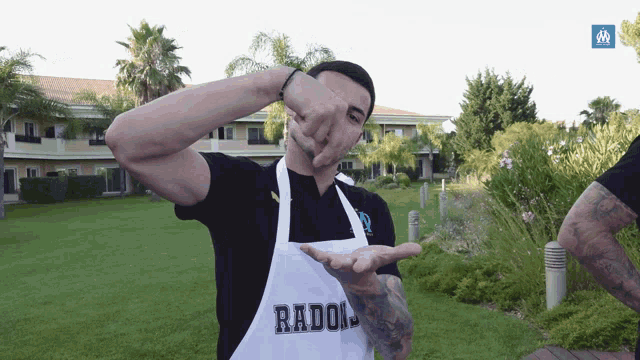 a man wearing a white apron that says radolj