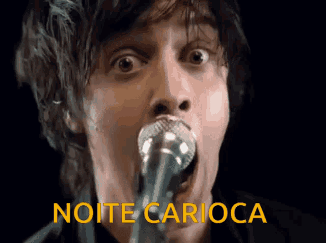 a man singing into a microphone with the words noite carioca written above him