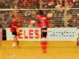 a blurry picture of a soccer game with a sign that says les on it