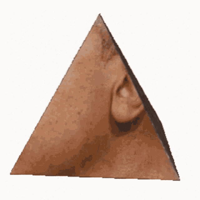 it looks like a pyramid with a person 's face on it .