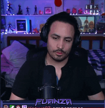 a man wearing headphones is sitting in front of a microphone with the word fuanza in the corner
