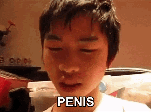 a young boy with his eyes closed has the word penis on his face