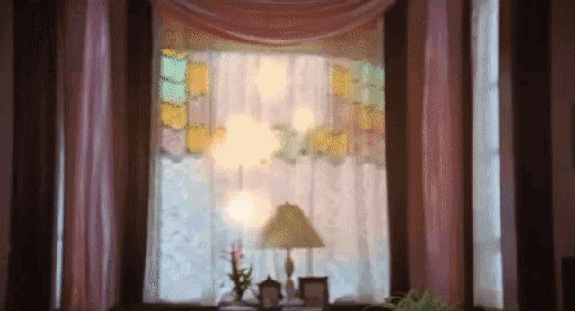 a lamp is sitting in front of a window with a stained glass window