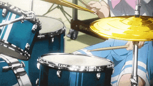 a person is playing drums with a yellow cymbal in the foreground