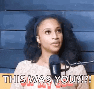 a woman is sitting in front of a microphone and says `` this was you ? ''