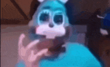 a blurry picture of a person wearing a blue and white bunny mask .
