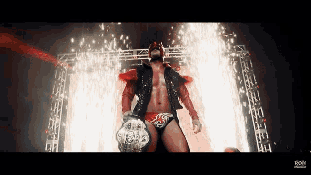 a wrestler is holding a world heavyweight wrestling championship