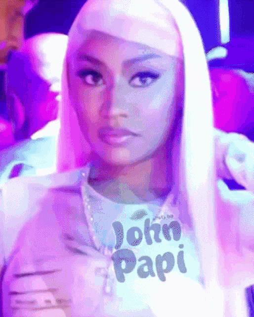 a woman with long blonde hair is wearing a t-shirt that says john papi