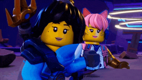 a couple of lego figures are standing next to each other .
