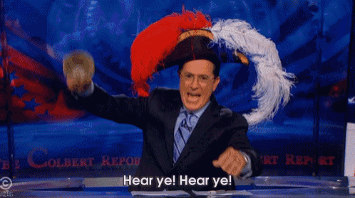 a man wearing a feathered hat says " hear ye hear ye "