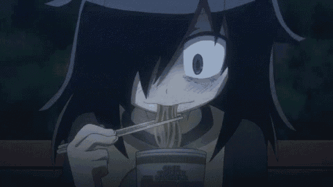 a girl is eating noodles with chopsticks and making a funny face .