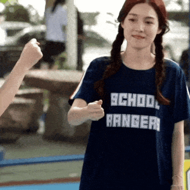 a girl wearing a blue school rangers shirt