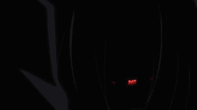 a close up of a person 's red eye with a black background
