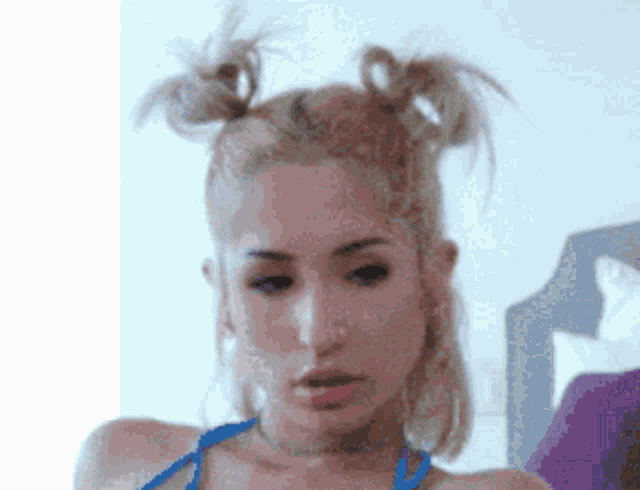 a close up of a woman 's face with two pigtails