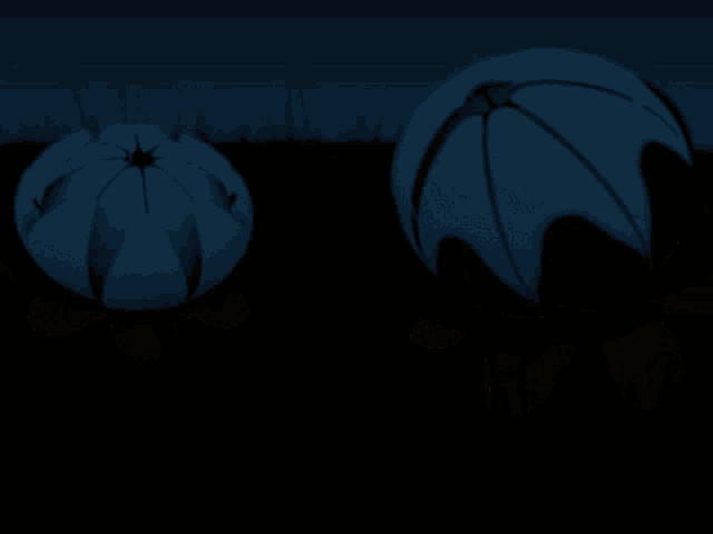 two pink balls are sitting in a field