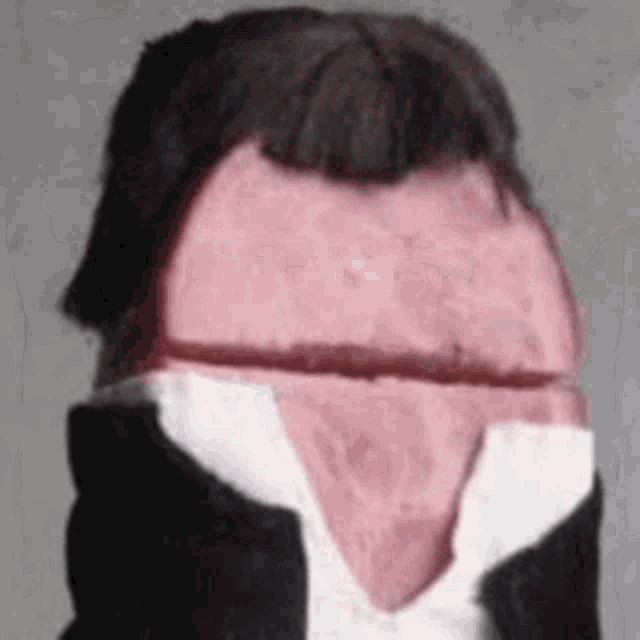 a close up of a piece of sausage with a man 's head and a bow tie .