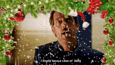 a man wearing a santa hat says " i finally have a case of jolly " in front of a christmas tree