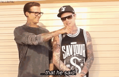 two men are standing next to each other and one of them is wearing a shirt that says saviour on it