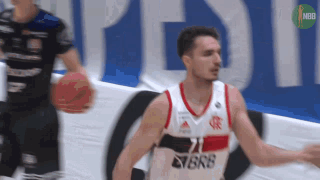 a basketball player with the number 21 on his jersey is dribbling the ball