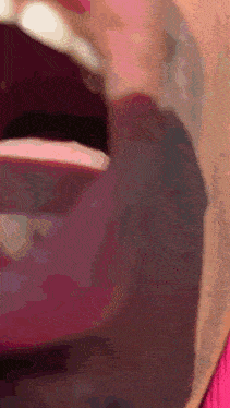 a close up of a person 's mouth with a pink lipstick on