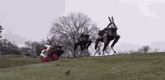 a robotic reindeer pulling a santa claus sleigh on a grassy hill