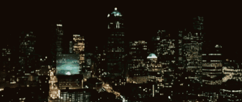 a blurry picture of a city at night with lots of buildings