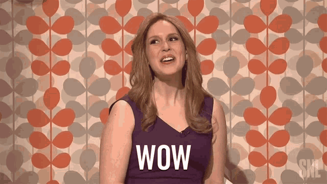 a woman in a purple dress with the word wow on her shirt