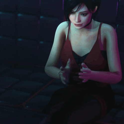 a woman wearing a choker and a red top is sitting with her hands folded