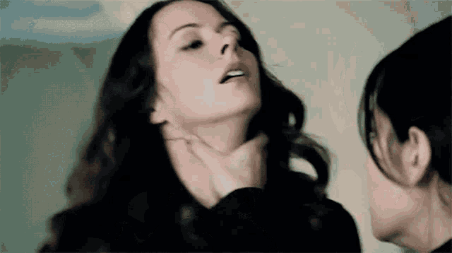 a woman is being choked by another woman 's hand .