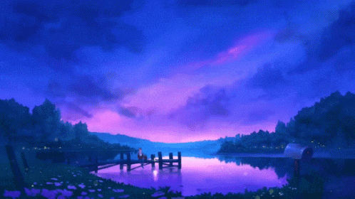a couple sits on a dock overlooking a lake