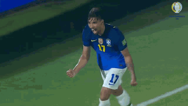 a soccer player with the number 17 on his shirt is celebrating a goal