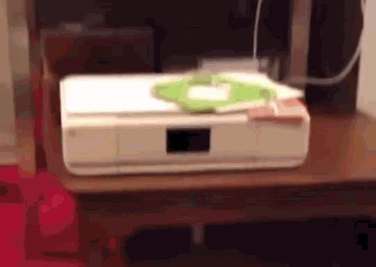 a white printer sits on a wooden table