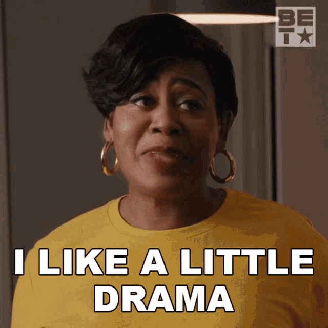 a woman says i like a little drama in a yellow shirt