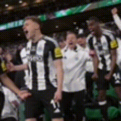 a blurred image of a group of soccer players wearing black and white striped shirts