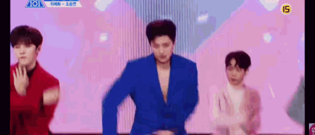 a man in a blue suit is dancing on a stage .