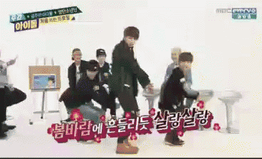 a group of young men are dancing in front of a sign that says mbc every ve