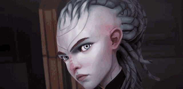 a woman with dreadlocks and a shaved head is looking at the camera .