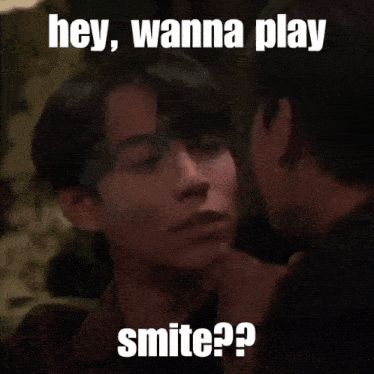 two men are kissing with the caption hey wanna play smite ?